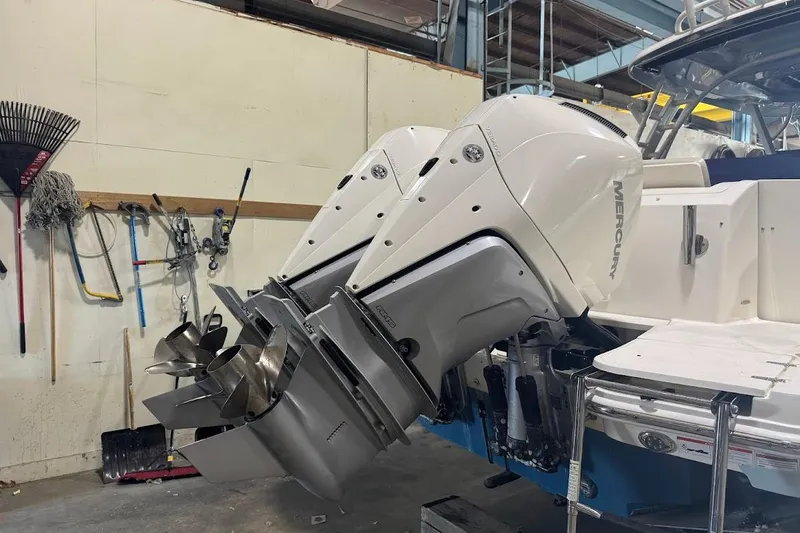 Slide: The Image of 2022 Boston Whaler 320 Vantage with dual Mercury outboard engines in a workshop. - 7