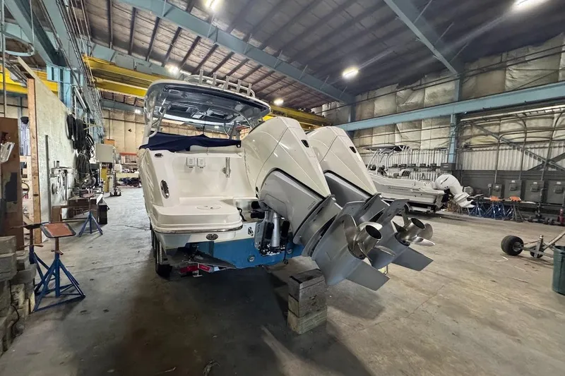 Slide: The Image of 2022 Boston Whaler 320 Vantage in a spacious indoor workshop setting. - 9