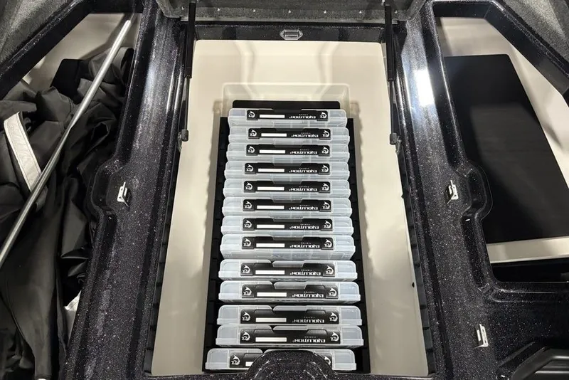 Slide: The Image of Storage compartment in 2026 Skeeter ZXE20 boat, featuring organized tackle boxes. - 14