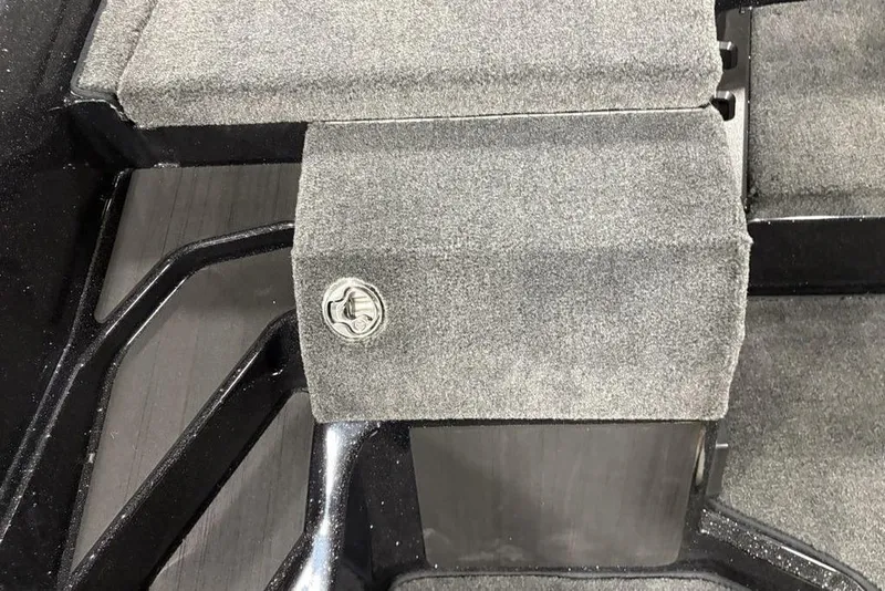 Slide: The Image of 2026 Skeeter ZXE20 interior with gray carpeted flooring and storage compartment. - 17