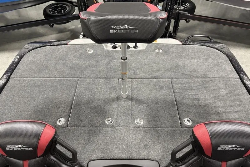 Slide: The Image of Skeeter ZXE20 2026 boat interior with cushioned seats and carpeted deck. - 24