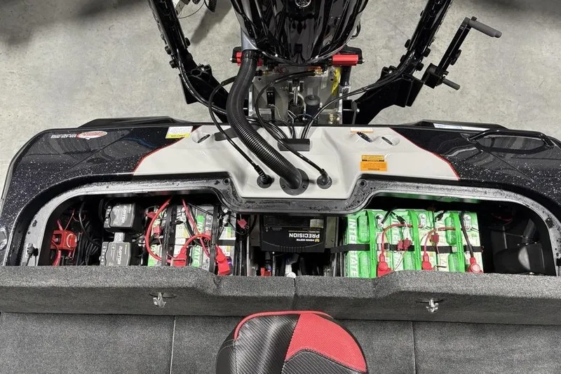 Slide: The Image of 2026 Skeeter ZXE20 boat battery compartment with multiple batteries and wiring. - 27