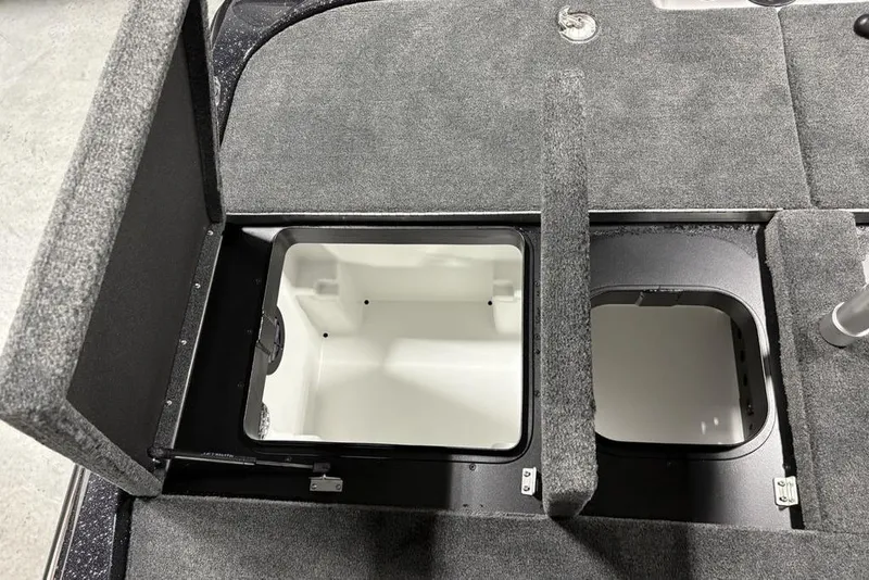 Slide: The Image of 2026 Skeeter ZXE20 boat storage compartments with open lids, showcasing interior space. - 29