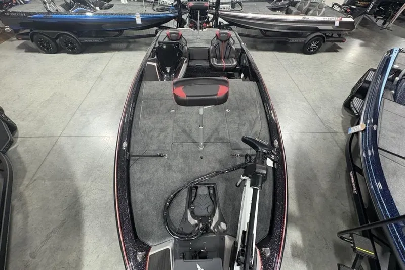 Slide: The Image of 2026 Skeeter ZXE20 fishing boat interior with seating and equipment, displayed in a showroom. - 32