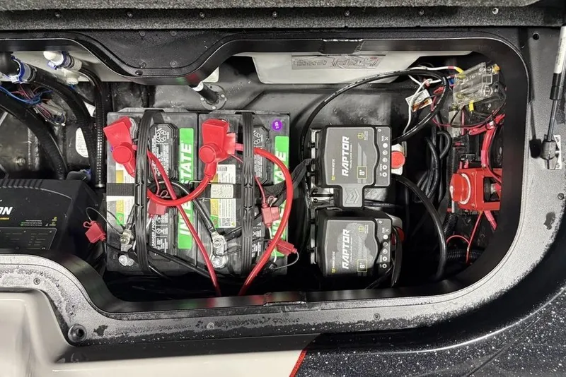 Slide: The Image of Battery compartment of a 2026 Skeeter ZXE20 boat, featuring Interstate batteries and wiring. - 33