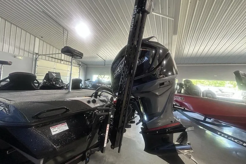 Slide: The Image of 2026 Skeeter ZXE20 boat with Yamaha outboard motor in a garage setting. - 35