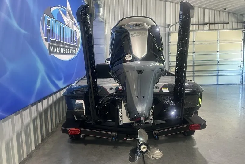 Slide: The Image of 2026 Skeeter ZXE20 boat in showroom, featuring powerful outboard motor and sleek design. - 36