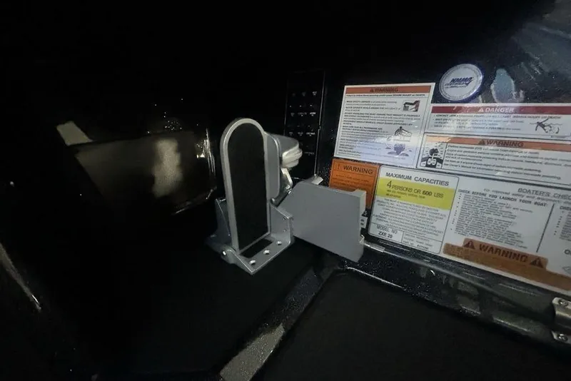Slide: The Image of Interior of 2026 Skeeter ZXE20 boat showing warning labels and mounting bracket. - 37