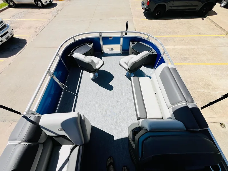 Slide: The Image of 2026 Sun Tracker Fishin' Barge 20 DLX pontoon boat interior with seating and fishing chairs. - 11