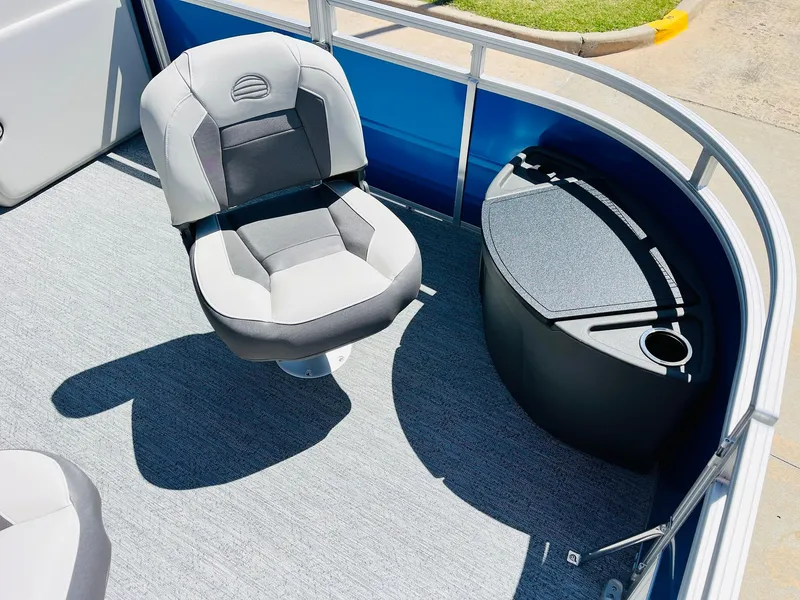 Slide: The Image of 2026 Sun Tracker Fishin' Barge 20 DLX interior with seating and storage compartment. - 13