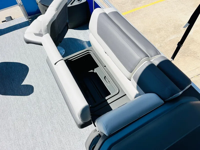 Slide: The Image of 2026 Sun Tracker Fishin' Barge 20 DLX interior with open storage compartment. - 20