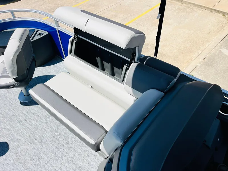 Slide: The Image of 2026 Sun Tracker Fishin' Barge 20 DLX interior seating with storage compartment. - 21