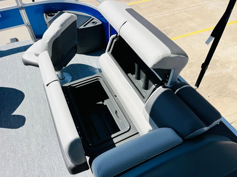 Slide: The Image of 2026 Sun Tracker Fishin' Barge 20 DLX interior with open storage compartment. - 22