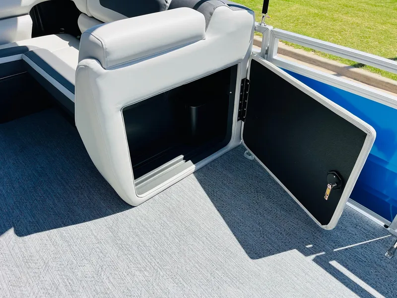 Slide: The Image of Open storage compartment on 2026 Sun Tracker Fishin' Barge 20 DLX pontoon boat. - 24