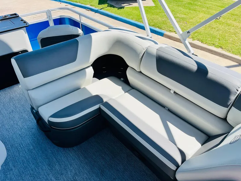 Slide: The Image of 2026 Sun Tracker Fishin' Barge 20 DLX interior with gray seating and carpeted flooring. - 26