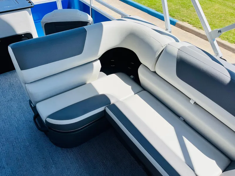 Slide: The Image of 2026 Sun Tracker Fishin' Barge 20 DLX interior with gray and white cushioned seating. - 30