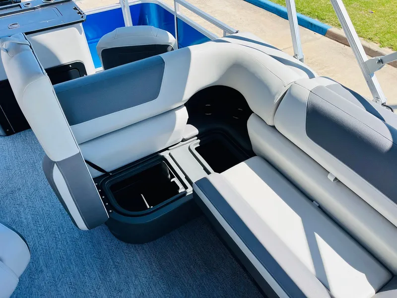Slide: The Image of 2026 Sun Tracker Fishin' Barge 20 DLX interior with storage compartments and seating. - 31
