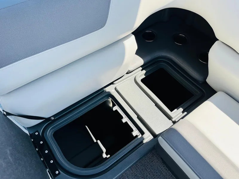 Slide: The Image of 2026 Sun Tracker Fishin' Barge 20 DLX storage compartments with cup holders. - 32