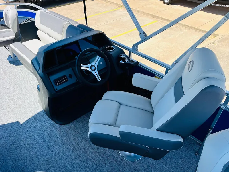 Slide: The Image of 2026 Sun Tracker Fishin' Barge 20 DLX boat interior with steering wheel and seating. - 33