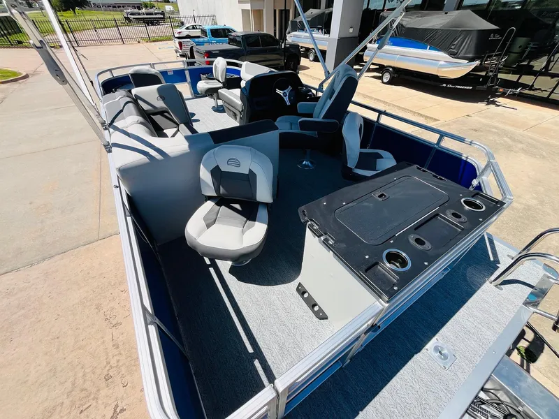 Slide: The Image of 2026 Sun Tracker Fishin' Barge 20 DLX pontoon boat interior with seating and control console. - 37