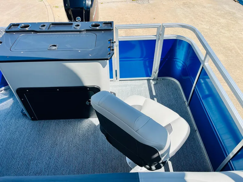 Slide: The Image of 2026 Sun Tracker Fishin' Barge 20 DLX interior with seating and control panel. - 39