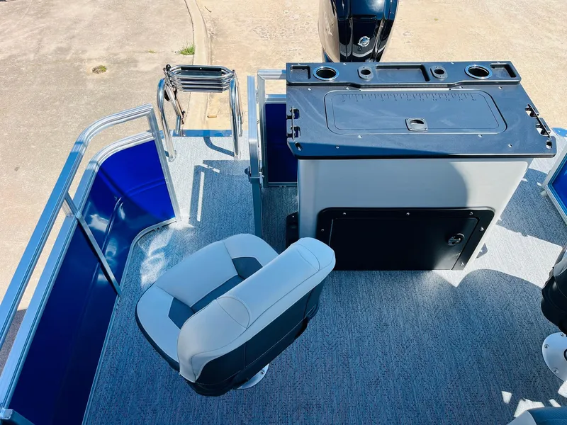 Slide: The Image of 2026 Sun Tracker Fishin' Barge 20 DLX interior with seating and control panel. - 42