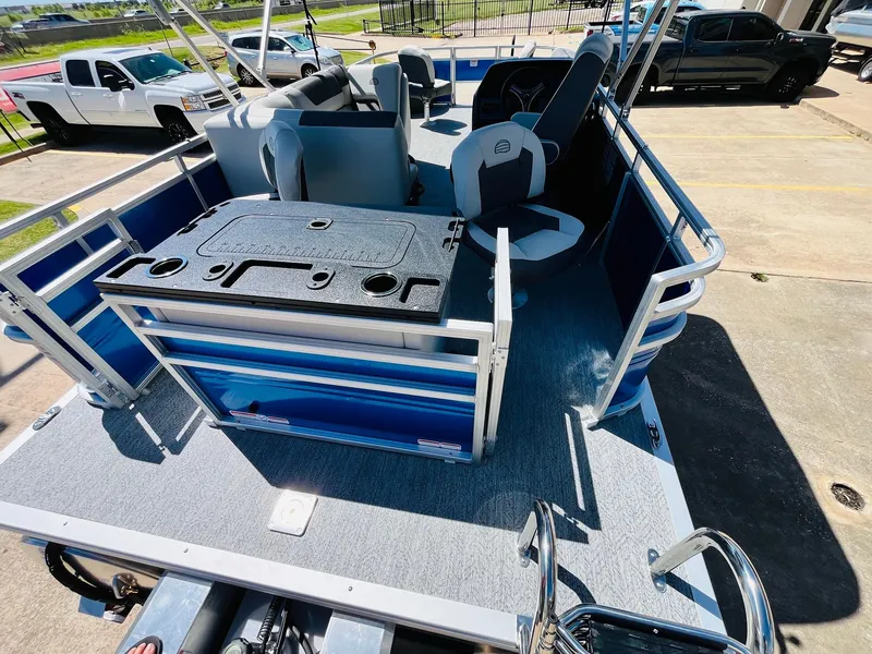 Slide: The Image of 2026 Sun Tracker Fishin' Barge 20 DLX pontoon boat interior with seating and fishing station. - 44