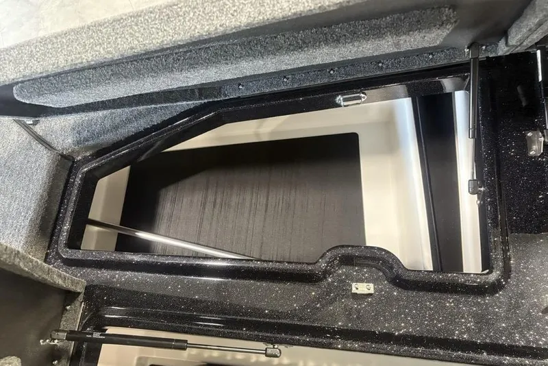 Slide: The Image of 2026 Skeeter ZXE20 boat storage compartment with open lid and hydraulic supports. - 14