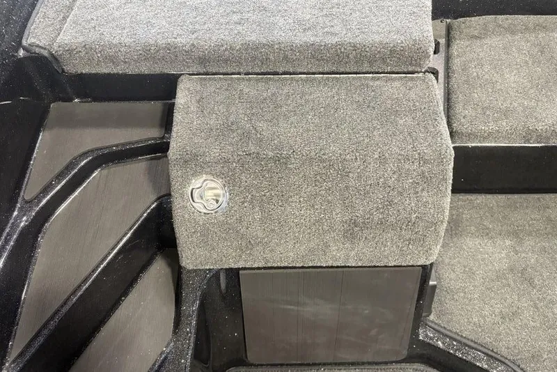 Slide: The Image of Carpeted storage compartment in a 2026 Skeeter ZXE20 boat interior. - 18