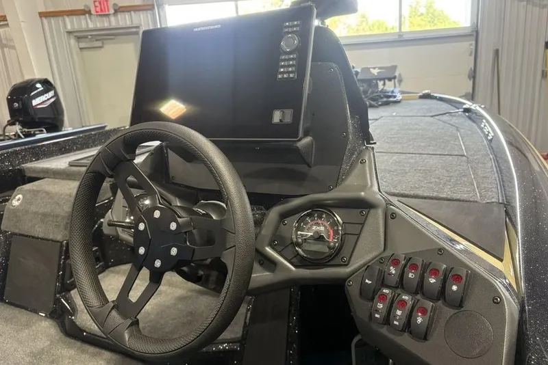 Slide: The Image of 2026 Skeeter ZXE20 boat dashboard with steering wheel and control panel. - 20