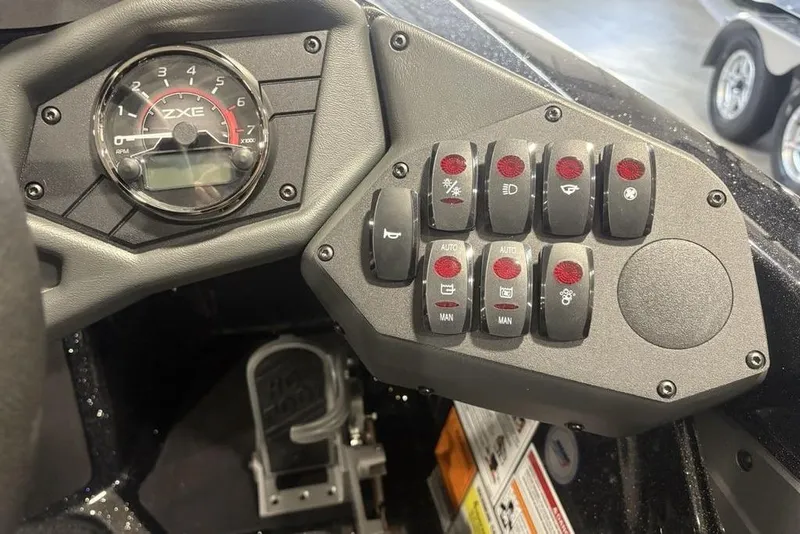 Slide: The Image of Dashboard of 2026 Skeeter ZXE20 boat with control switches and RPM gauge. - 22