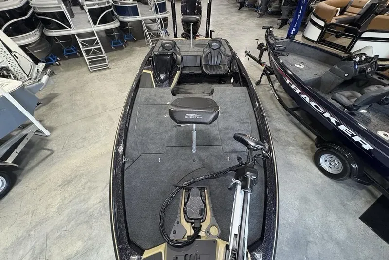 Slide: The Image of 2026 Skeeter ZXE20 fishing boat in showroom, featuring spacious deck and seating. - 32