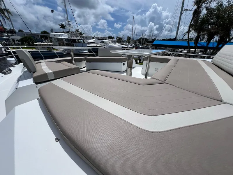 Slide: The Image of Luxurious seating area on 2020 Galeon 680 Fly yacht, docked with other yachts nearby. - 12