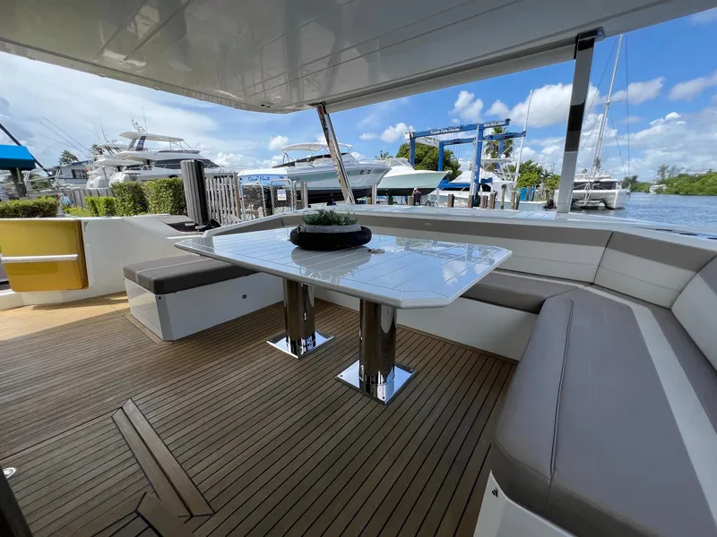 Slide: The Image of Luxurious seating area on a 2020 Galeon 680 Fly yacht, featuring elegant wood decking. - 17