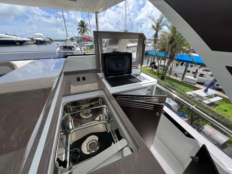 Slide: The Image of Luxurious 2020 Galeon 680 Fly yacht deck with elegant seating and table, docked at marina. - 18