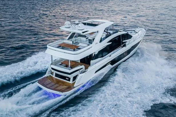 Slide: The Image of 2020 Galeon 680 Fly yacht cruising on open sea with clear blue skies. - 2
