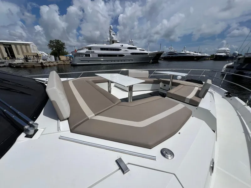 Slide: The Image of 2020 Galeon 680 Fly yacht with spacious deck seating, docked in a marina. - 9