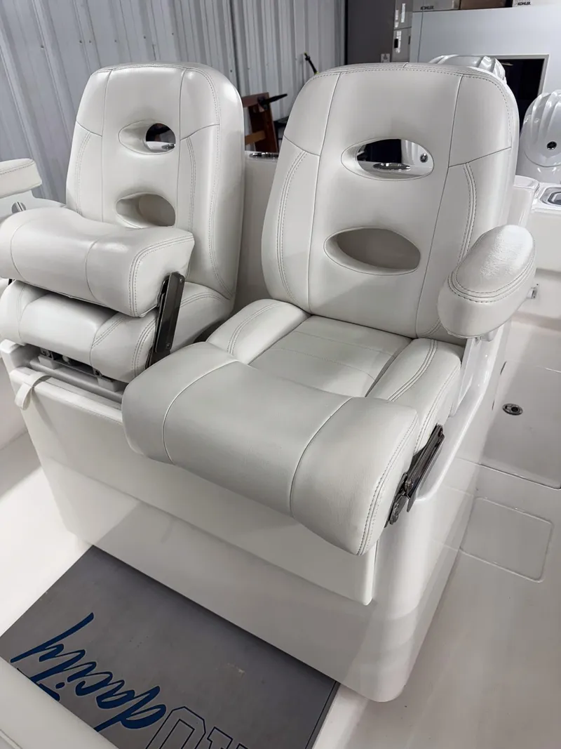 Slide: The Image of Luxury white seating on 2022 Contender 32 ST boat, featuring plush design and armrests. - 3