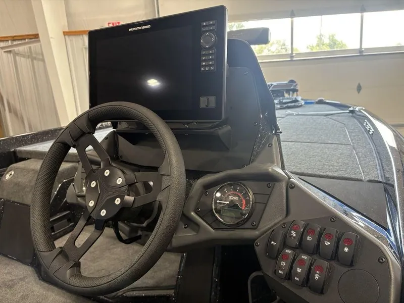 Slide: The Image of 2026 Skeeter ZXE20 boat dashboard with steering wheel and control panel. - 13