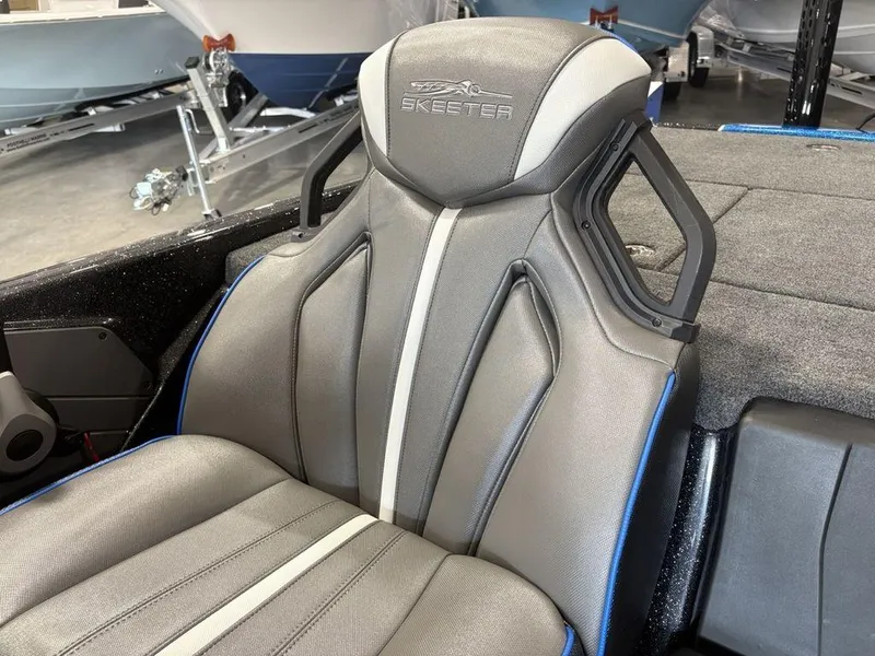 Slide: The Image of 2026 Skeeter ZXE20 boat seat with sleek gray design and blue accents. - 14