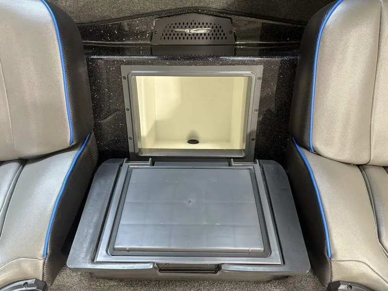 Slide: The Image of 2026 Skeeter ZXE20 boat interior with open storage compartment between seats. - 16