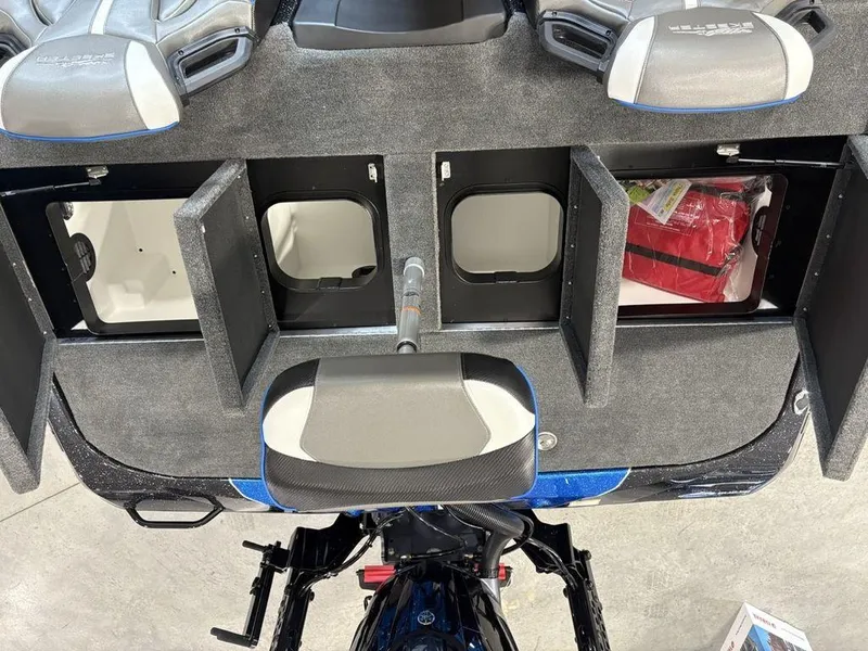 Slide: The Image of 2026 Skeeter ZXE20 boat storage compartments with open lids and visible seating. - 19