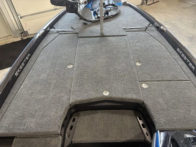 Slide: The Image of 2026 Skeeter ZXE20 boat deck with gray carpet and storage compartments. - 4