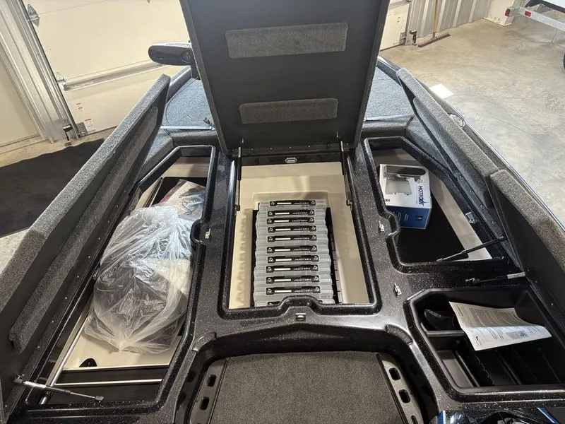 Slide: The Image of 2026 Skeeter ZXE20 boat storage compartments with organized tackle boxes and accessories. - 7