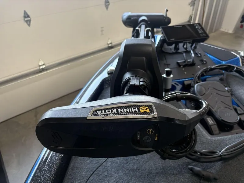Slide: The Image of 2026 Skeeter ZXE20 boat with Minn Kota trolling motor in a garage setting. - 9