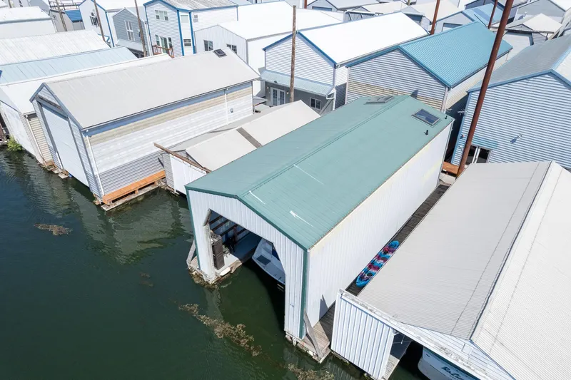 Slide: The Image of Aerial view of custom 1970 boathouses with green roofs on a calm waterfront. - 10