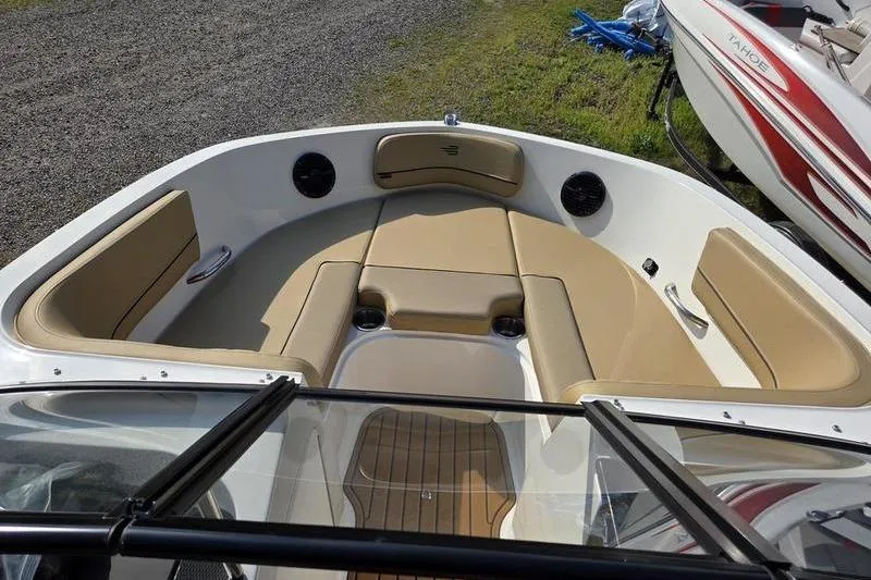 Slide: The Image of 2025 Bayliner VR5 OB boat interior with tan seating and cup holders. - 7