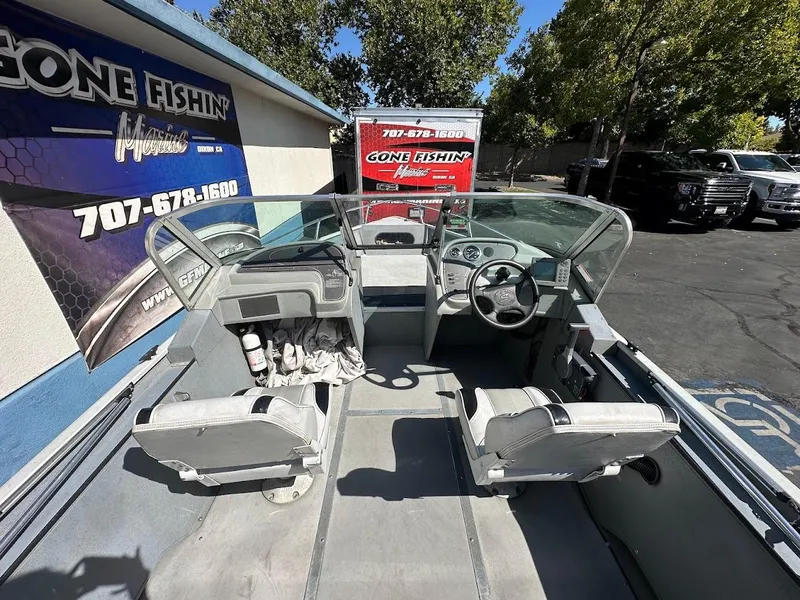 Slide: The Image of 2001 Smoker Craft 160 SP boat interior with steering wheel and seats, parked at Gone Fishin' Marine. - 10