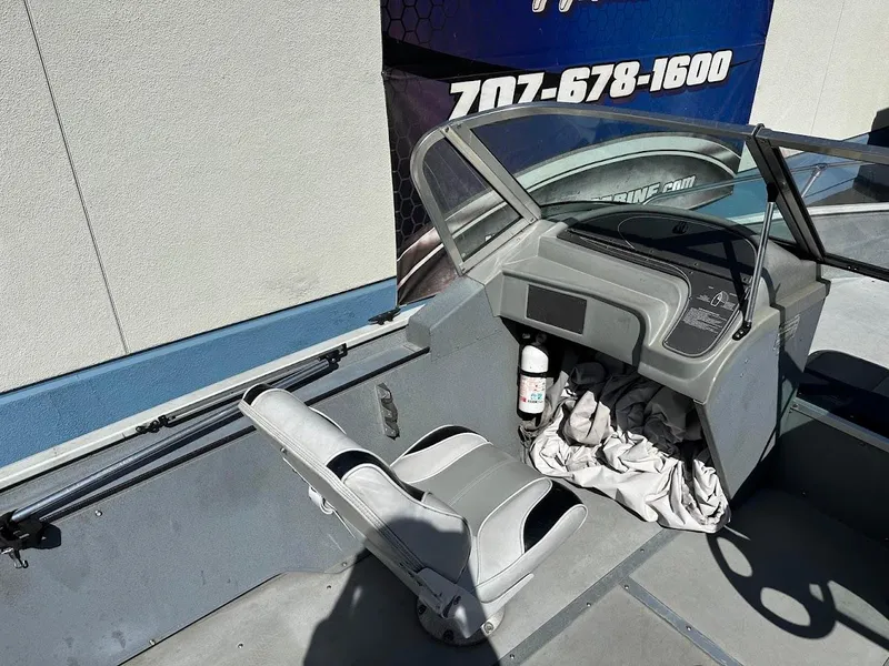 Slide: The Image of 2001 Smoker Craft 160 SP boat interior with steering console and seat. - 11