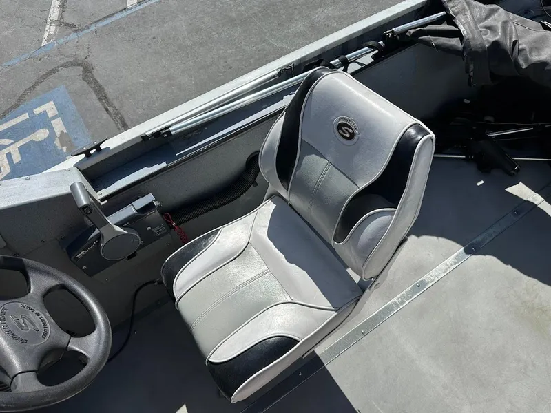 Slide: The Image of 2001 Smoker Craft 160 SP boat interior with steering wheel and seat. - 14